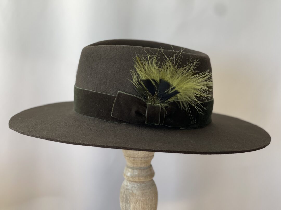 Brown felt fedora with green feather