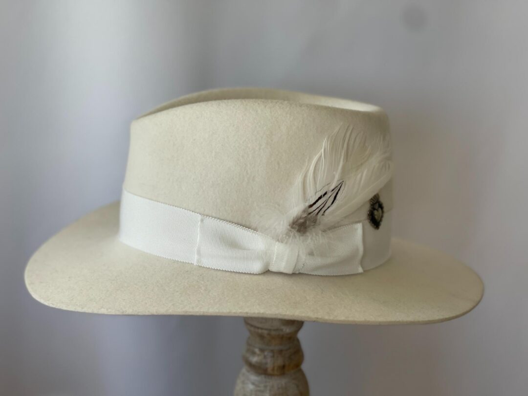 Ivory fedora hat with white ribbon and feather