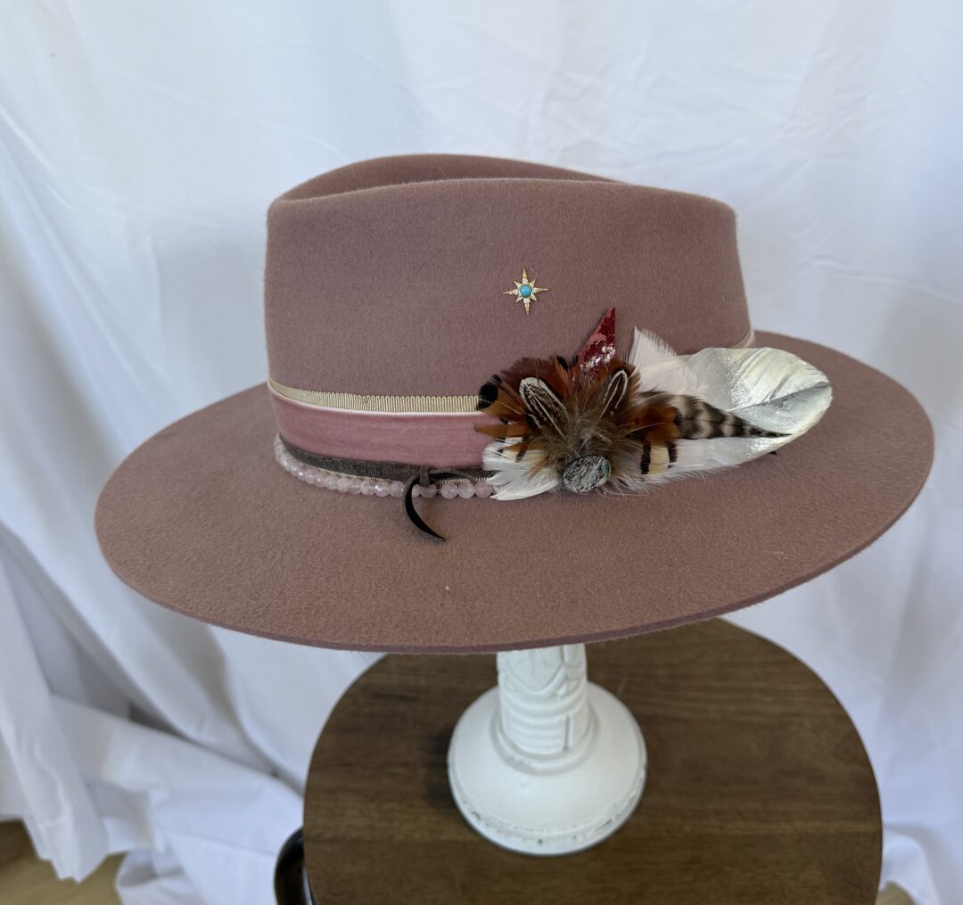 Mauve felt fedora with feather and star pin